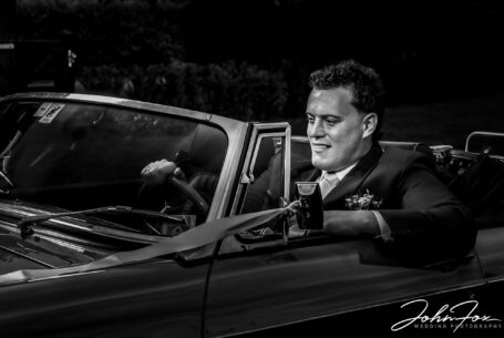 Wedding photographer in Oxfordshire at Primrose Hill Farm. Groom in the wedding car.