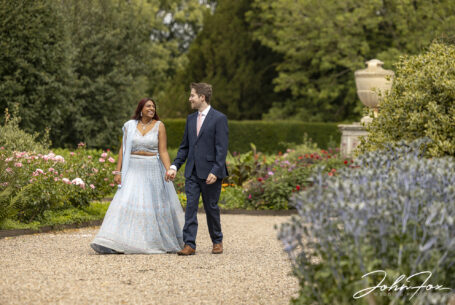 Jenna and Oliver’s wedding day at Ragley Hall, Warwickshire. The couple walking in the grounds of the Hall.