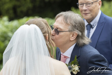 Hugs and kisses of congratulations from wedding guests at Ansty Hall.