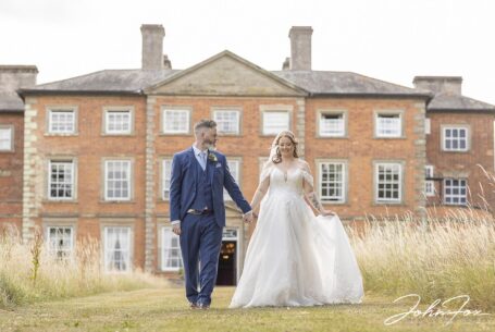 Bride and groom walking in the grounds at Ansty Hall.