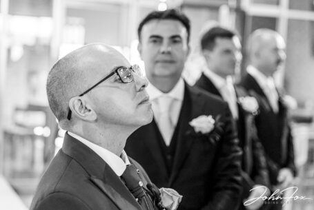 Groom and groomsmen in church awaiting the bride