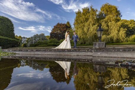 Bride and groom at Putteridge Hall, reflection in the pond