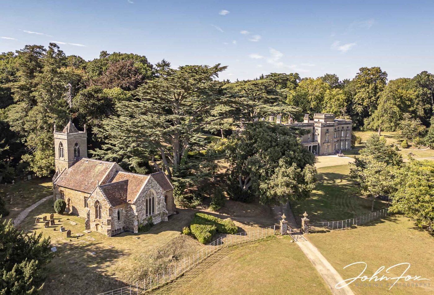 Aerial shot of a church right next to a manor house wedding venue. Help Planning Your Wedding Hints Tips and Advice – Venues