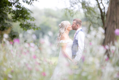 The newlyweds kissing in the grounds at Kilworth House, Leicestershire. Help Planning Your Wedding Hints Tips and Advice – Photography