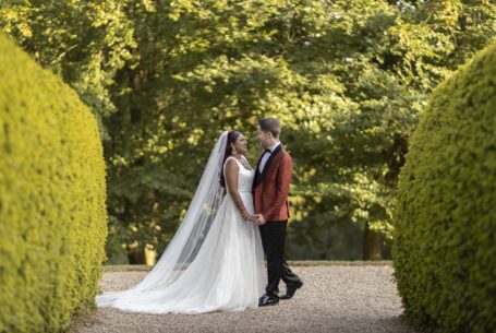 Ragley Hall in Warwickshire. Image of the bride and groom no longer wearing Indian dress: now the bride is in a white wedding dress and the groom in a suit.