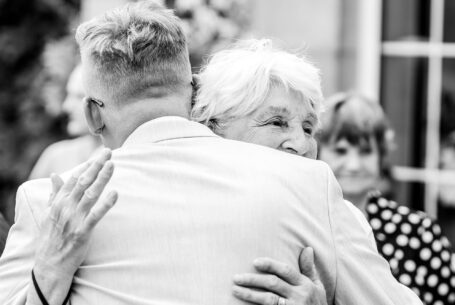 Help Planning Your Wedding Hints Tips and Advice – Part 9 - Groom and his grandmother embrace after the wedding ceremony at Whittlebury Park, Northamptonshire. Image by John Fox