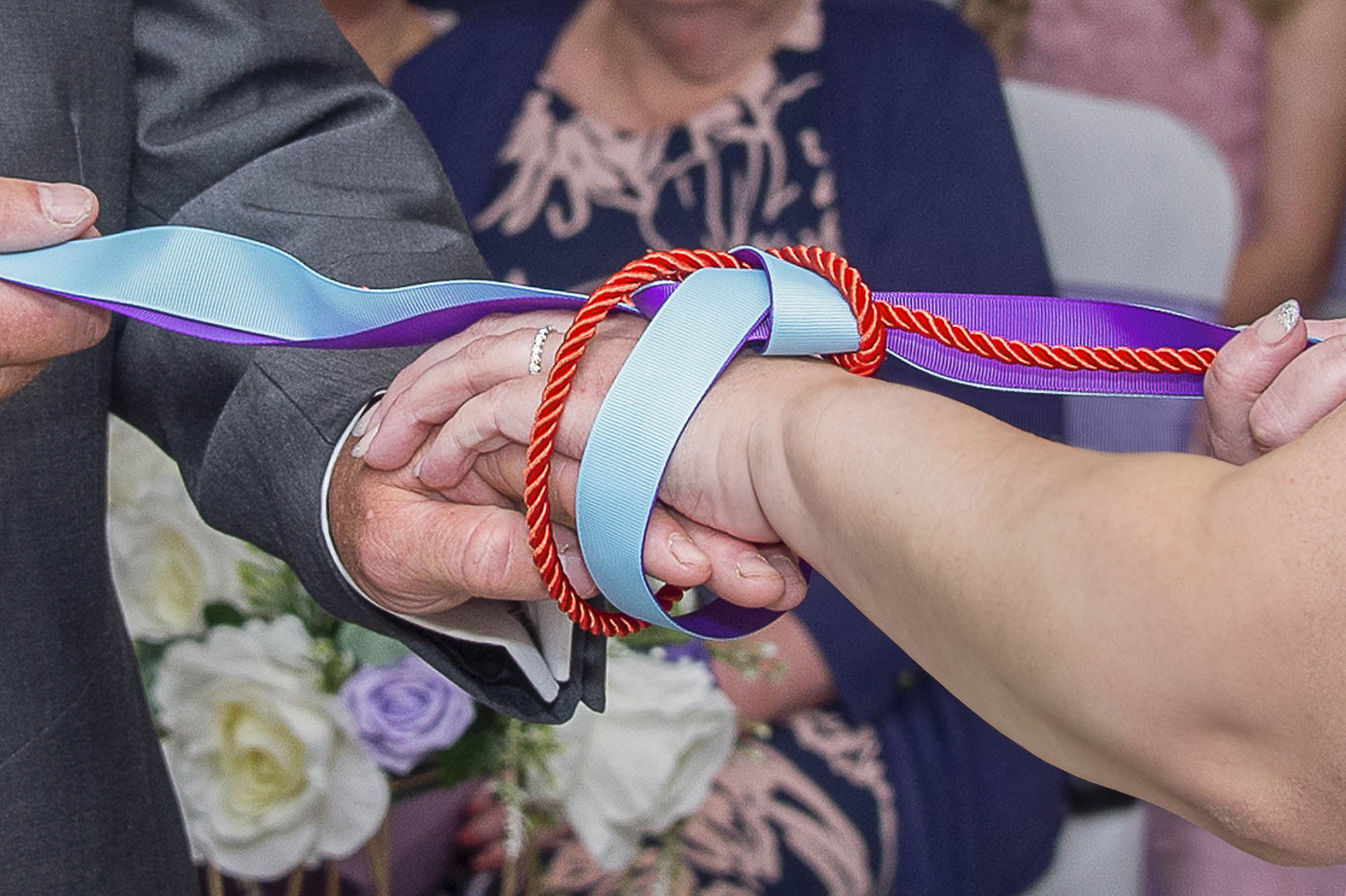 Help Planning Your Wedding Hints Tips and Advice - Styling Advice. Image of Hand tying tradition where a couple tie the knot