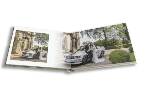 Wedding album showing a relaxed photo of the newlyweds with wedding car at Kilworth House gardens – photographed by Mike, album designed by John Fox