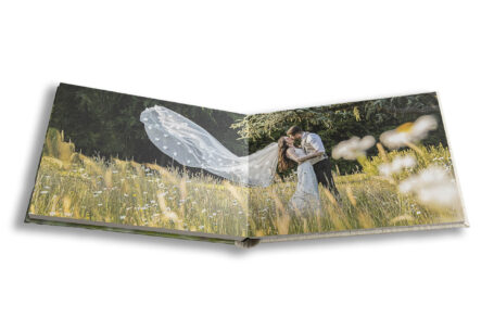 Golden hour couple portrait at Kilworth House, Leicestershire with the bride's veil caught by the breeze