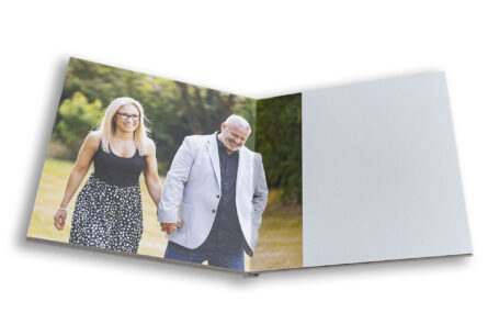 Wedding guest book showing bride and groom to be walking the the grounds at The Five Bells Pub in Bedfordshire.