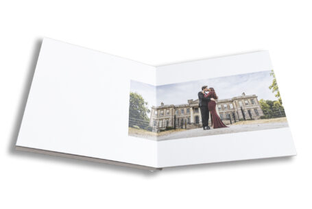 Jenna and Oliver outside Ragley Hall with the wedding venue in the background.
