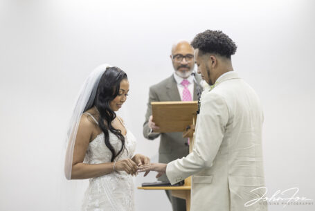 Bride and groom exchanging wedding rings. Image by John Fox Wedding Photography