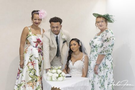 Zoe and Kai signing the register. Image by John Fox Wedding Photography.