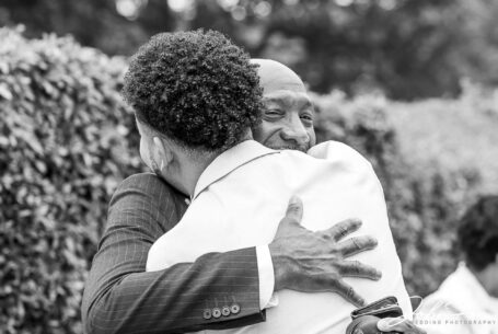 Kai, the groom, hugging his father-in-law at his Birmingham wedding.