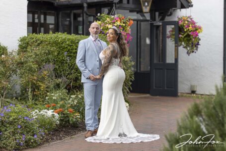 Wedding photographer in Bedfordshire, John Fox, capturing an image of the happy couple outside the Kingfisher Hotel