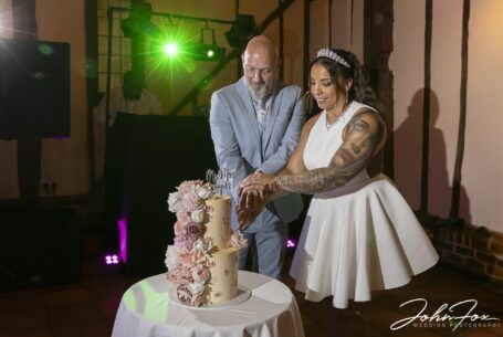 Bride and groom cutting the cake at their Bedfordshire wedding