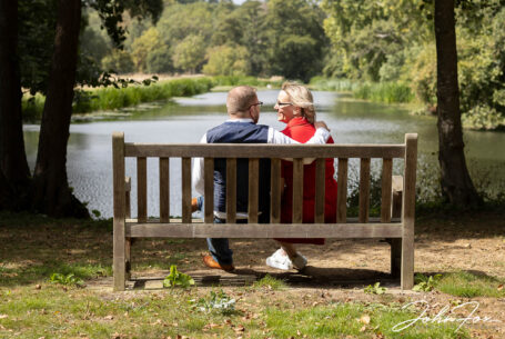Bride and groom, Joanne and Kevin, on a pre-wedding shoot in the grounds of Rushton Hall sitting by the lake