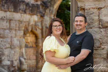 Pre-wedding shoot image of couple by old stone wall in Leicestershire. Image by John Fox