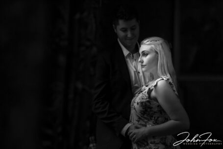Pre-wedding shoot by a window using natural light at Kilworth House by recommended wedding photographer John Fox.