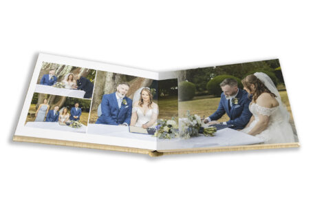 Natalie and Simon's Wedding Album showing images of them signing the wedding register at their Ansty Hall wedding.