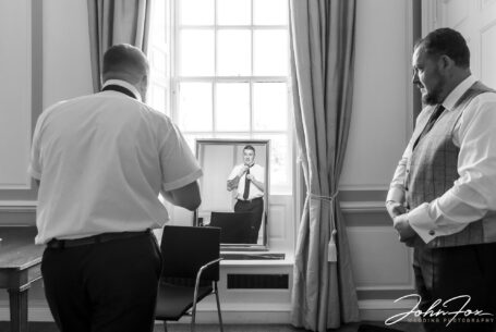 Groom preparations at Chicheley Hall in Buckinghamshire. Elliot and best man getting ready.