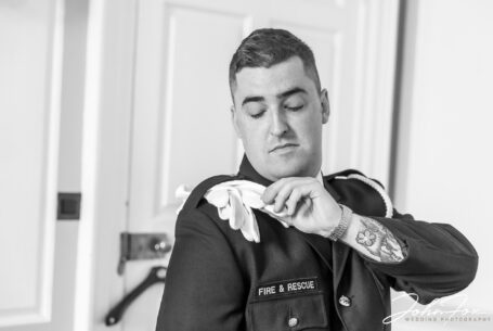 Groom preparations at Chicheley Hall in Buckinghamshire. Elliot in his fireman's ceremonial uniform.