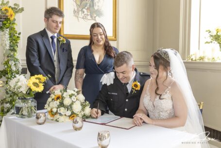 Wedding ceremony, Grace and Elliot signing the register. Image by John Fox Wedding Photography.