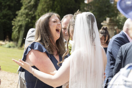 Wedding guests congratulating the bride, Grace, at Chicheley Hall in Buckinghamshire