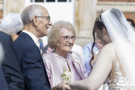 The bride chatting with her wedding guests at Chicheley Hall in Buckinghamshire. Photo by John Fox Wedding Photography