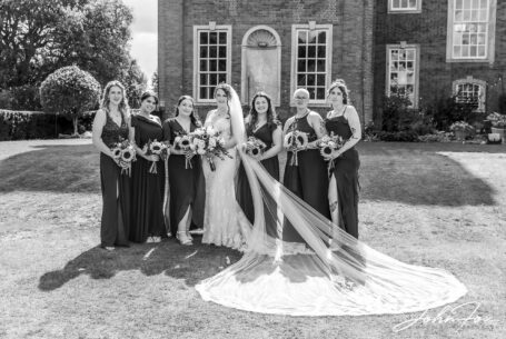 Black and white photo of the bridal party at Chicheley Hall in Buckinghamshire. Photo by John Fox Wedding Photography