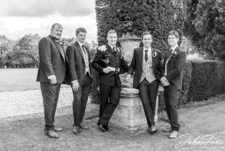 Groom and groomsmen in the grounds at Chicheley Hall in Buckinghamshire. Image by John Fox Wedding Photography.