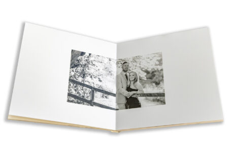 Wedding guest book featuring images from a pre-wedding shoot at Fawsley Estate in Northamptonshire. Photo by John Fox Wedding Photography.