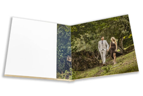 Pre-wedding shoot at Fawsley Estate in Northamptonshire for Tanya and Shane. Image of the couple walking together and laughing.