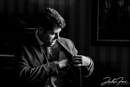 Groom preparations - Daniel putting his speech in his jacket pocket at Kilworth House