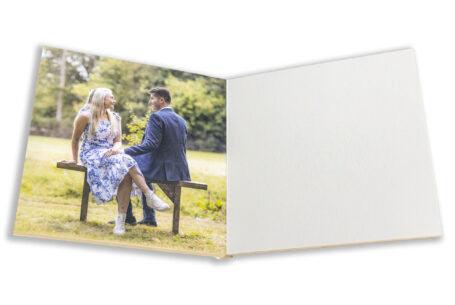 Pre-wedding shoot image by John Fox at Kilworth House in Leicestershire of the bride and groom to be sitting on a bench