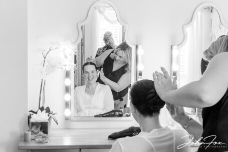 Gabrielle getting ready for the ceremony at Kingscote Barn in Tetbury. Image by John Fox Wedding Photography.