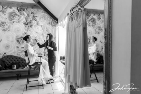 Gabrielle having her makeup applied in preparation for her Cotswolds' wedding at Kingscote Barn, Tetbury