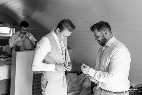 Groomsmen getting ready at Cotswold wedding venue Kingscote Barn in Tetbury