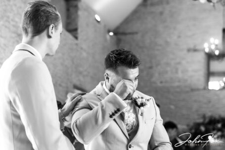 William, the groom, getting emotional at this wedding at Kingscote Barn, Tetbury