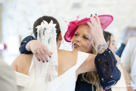 Gabrielle the bride being congratulated by a guest at Kingscote Barn