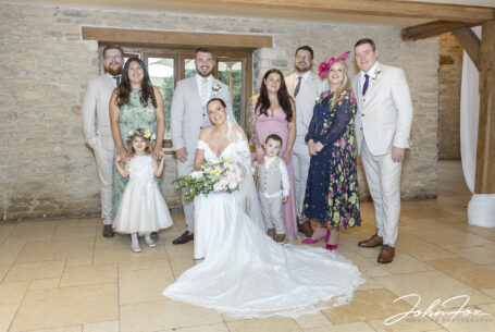 Wedding family group photo inside at Kingscote Barn, Tetbury