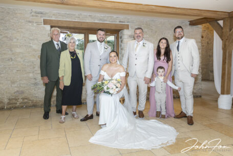 Family group photo at Kingscote Barn for Gabrielle and William’s wedding