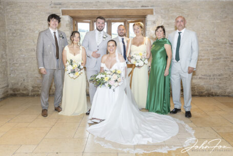 Gabrielle and William’s family group photo inside Kingscote Barn, Tetbury