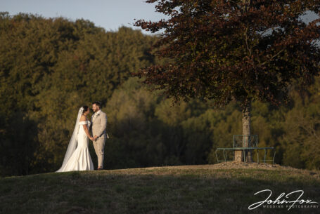 Bride and groom portrait in the grounds at Kingscote Barn.
