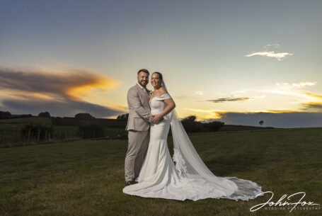 Bride and groom with a glorious Gloucestershire sunset at Kingscote Barn, Tetbury