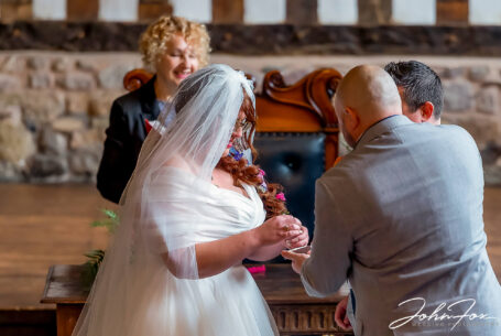 The best man handing over the rings. Wedding Photography in Leicester by John Fox.