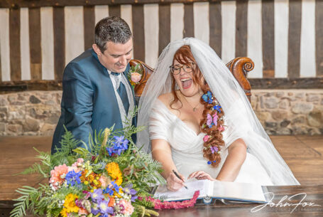 Bride and groom signing the register at the Guildhall, Leicester. Wedding Photography in Leicester