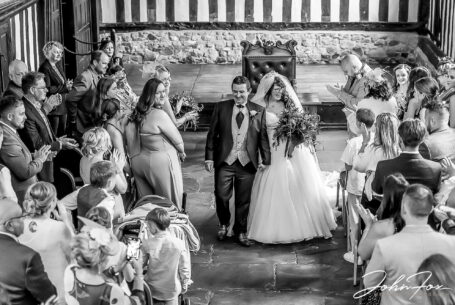 Amy and Karl, bride and groom, walking down the aisle at Guildhall, Leicester.
