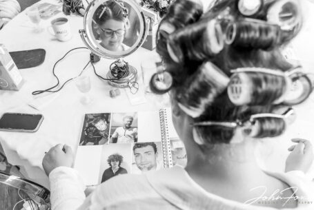 The bride looking at a photo album. Image by Staffordshire wedding photographer John Fox.