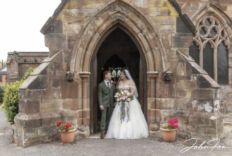 Sarah and Lewis leaving Ashley St John the Baptist Church in Staffordshire after their wedding ceremony.